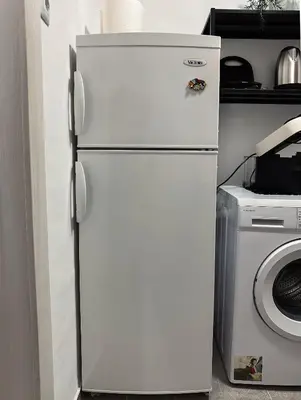 a white refrigerator in a kitchen next to a washing machine at Kallithea Zen Studios-Near Filopappou & Koukaki in Athens