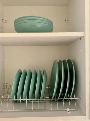 a row of green plates on a shelf at Mint Luxury Residence in Spáta