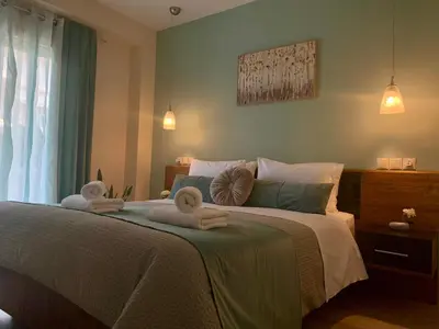 a bedroom with a bed with towels on it at Mint Luxury Residence in Spáta