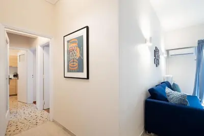 a room with a blue couch and a picture on the wall at Superb Family Apt In The Center Of Athens in Athens