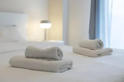 two towels sitting on top of a bed at Superb Family Apt In The Center Of Athens in Athens