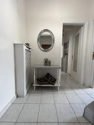 a white room with a table and a mirror at FeelAthens36 - very close to Syntagma, city center in Athens