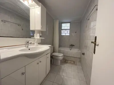 a white bathroom with a sink and a toilet at FeelAthens36 - very close to Syntagma, city center in Athens