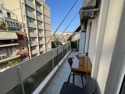 a balcony with a table and chairs on a building at FeelAthens36 - very close to Syntagma, city center in Athens