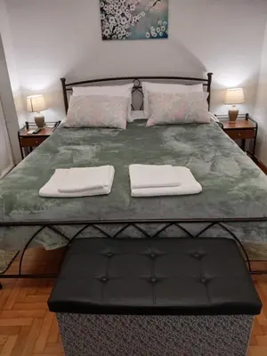 a bedroom with a large bed with two towels on it at FeelAthens36 - very close to Syntagma, city center in Athens