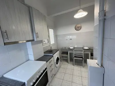 a kitchen with a stove and a table in it at FeelAthens36 - very close to Syntagma, city center in Athens