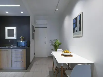 a kitchen and dining room with a table and chairs at Modern Haven near Archaeological Museum in Athens