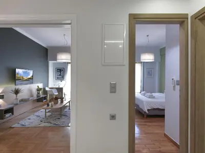 a living room with a bedroom and a bed at Modern Haven near Archaeological Museum in Athens