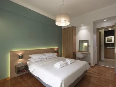 a bedroom with a bed with two towels on it at Modern Haven near Archaeological Museum in Athens