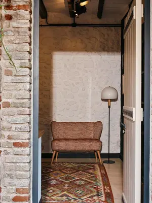 a chair in a hallway next to a brick wall at Not Boutique Hotel in Athens