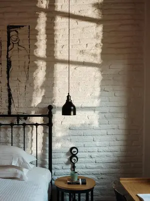 a bedroom with a bed and a brick wall at Not Boutique Hotel in Athens