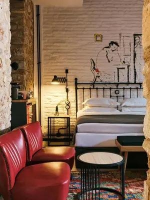 a bedroom with a bed and a couch and a chair at Not Boutique Hotel in Athens