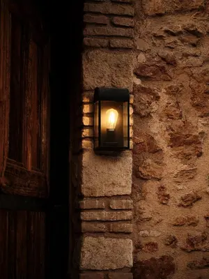 a light on the side of a stone wall at Not Boutique Hotel in Athens