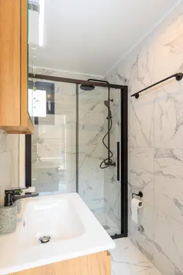 a bathroom with a sink and a shower at Aiolos Rooftop JUCCUZI with view near the centre NEA smyrni in Athens