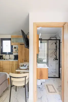 a kitchen and living room with a sink and a table at Aiolos Rooftop JUCCUZI with view near the centre NEA smyrni in Athens