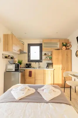 a kitchen with a large bed in a room at Aiolos Rooftop JUCCUZI with view near the centre NEA smyrni in Athens