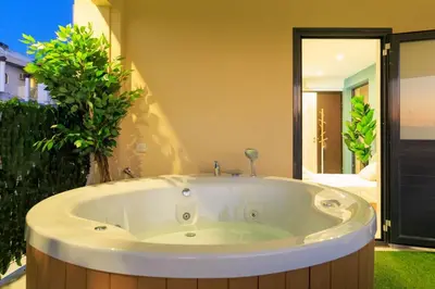 a large bath tub in a room with at Aiolos Rooftop JUCCUZI with view near the centre NEA smyrni in Athens