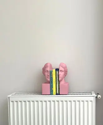 two books sitting on top of a radiator at Bright 2 bdr Pagrati apartment in Athens