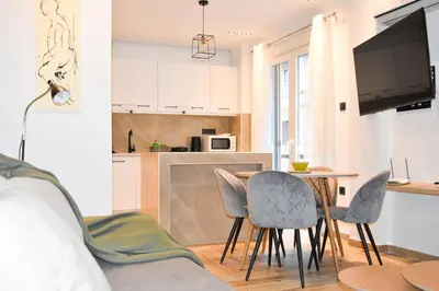 a kitchen and a living room with a table and chairs at Apartment in Athens Neos Kosmos in Athens