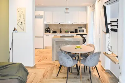 a kitchen with a table and chairs in a room at Apartment in Athens Neos Kosmos in Athens