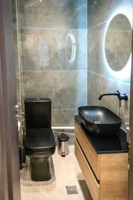 a bathroom with a black sink and a toilet at Apartment in Athens Neos Kosmos in Athens