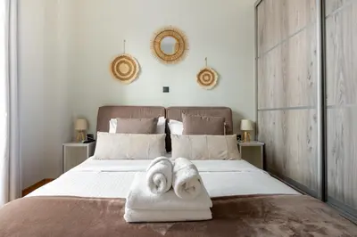 a bedroom with a bed with towels on it at Cesily 2-Bedroom Apartment in Athens in Athens
