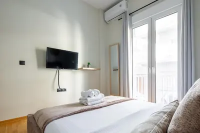 a bedroom with a bed with a towel on it at Cesily 2-Bedroom Apartment in Athens in Athens