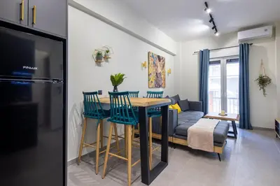 a kitchen and living room with a table and chairs at Cesily 2-Bedroom Apartment in Athens in Athens