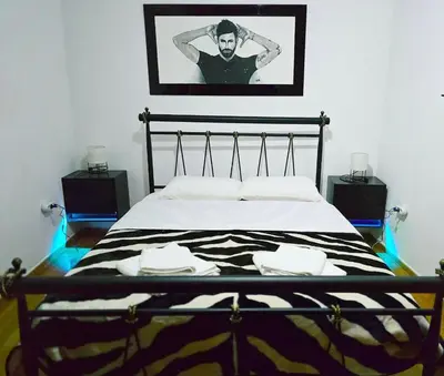 a bedroom with a bed with a black and white blanket at Nicko’s room in Piraeus