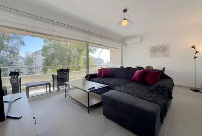 a living room with a couch and a large window at Kanari Sea View 55sqm apt in Alimos in Athens