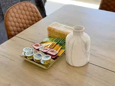 a table with a white vase and a tray of food at Kanari Sea View 55sqm apt in Alimos in Athens