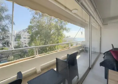 a room with a large window with a view of the ocean at Kanari Sea View 55sqm apt in Alimos in Athens
