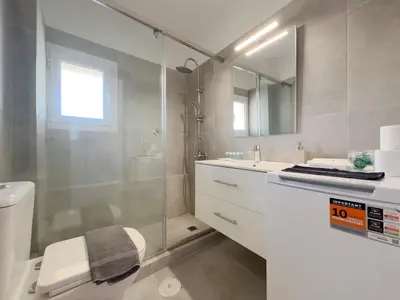 a bathroom with a shower and a toilet and a sink at Kanari Sea View 55sqm apt in Alimos in Athens
