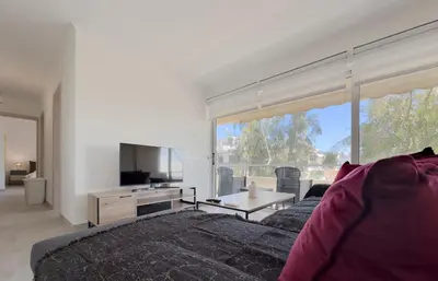 a living room with a couch and a large window at Kanari Sea View 55sqm apt in Alimos in Athens