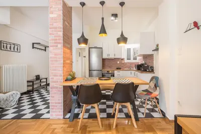 a kitchen and dining room with a table and chairs at Quiet Embassy Suite by CloudKeys in Athens