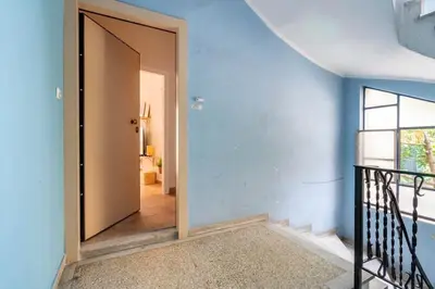 a door leading into a room with a hallway at STM Monastiraki Acropolis Apt in Athens