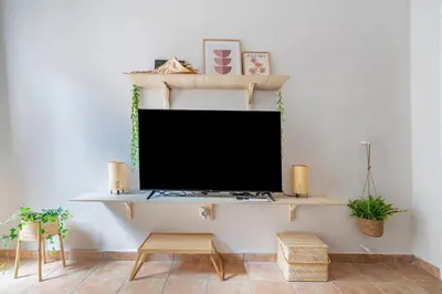 a living room with a flat screen tv on a wall at STM Monastiraki Acropolis Apt in Athens