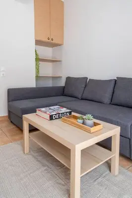 a living room with a blue couch and a coffee table at STM Monastiraki Acropolis Apt in Athens