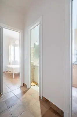 a white room with two mirrors and a bathroom at STM Monastiraki Acropolis Apt in Athens