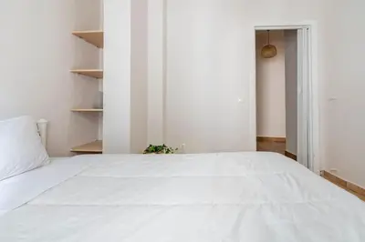 a large white bed in a white bedroom at STM Monastiraki Acropolis Apt in Athens