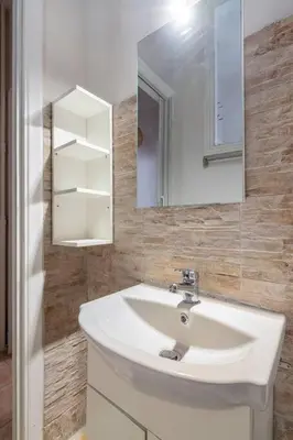 a bathroom with a white sink and a mirror at STM Monastiraki Acropolis Apt in Athens