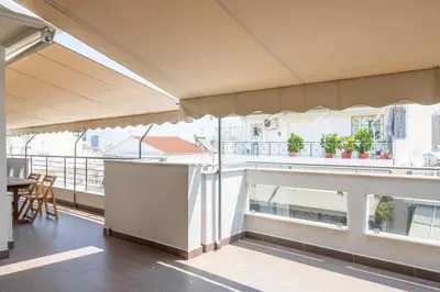 a balcony of a building with a table and chairs at Comfort 1BR apt with amazing balcony at Piraeus in Piraeus