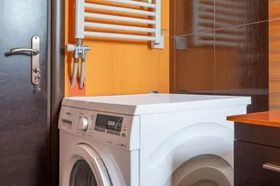 a washer and dryer in a kitchen with a counter at Comfort 1BR apt with amazing balcony at Piraeus in Piraeus