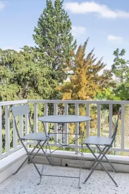 two chairs and a table on a balcony at Amazing location - 2 min from Acropolis in Athens
