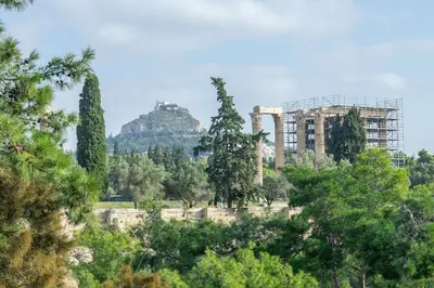 a building in the middle of a forest of trees at Amazing location - 2 min from Acropolis in Athens