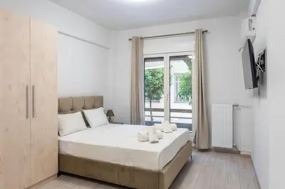 a bedroom with a large bed and a window at New and renovated studio close to Megaro Mousikis in Athens