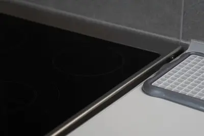 a laptop computer sitting on a counter with a keyboard at New and renovated studio close to Megaro Mousikis in Athens