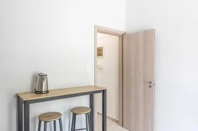 a room with a table and two stools at New and renovated studio close to Megaro Mousikis in Athens