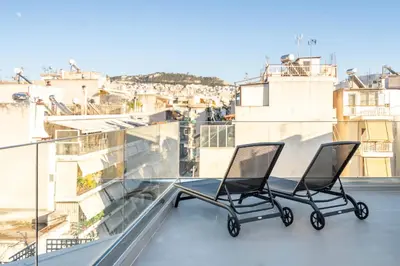 two chairs sitting on top of a balcony at Penthouse with views close to Monastiraki metro in Athens