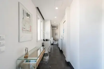 a hallway with a glass table and white walls at Penthouse with views close to Monastiraki metro in Athens